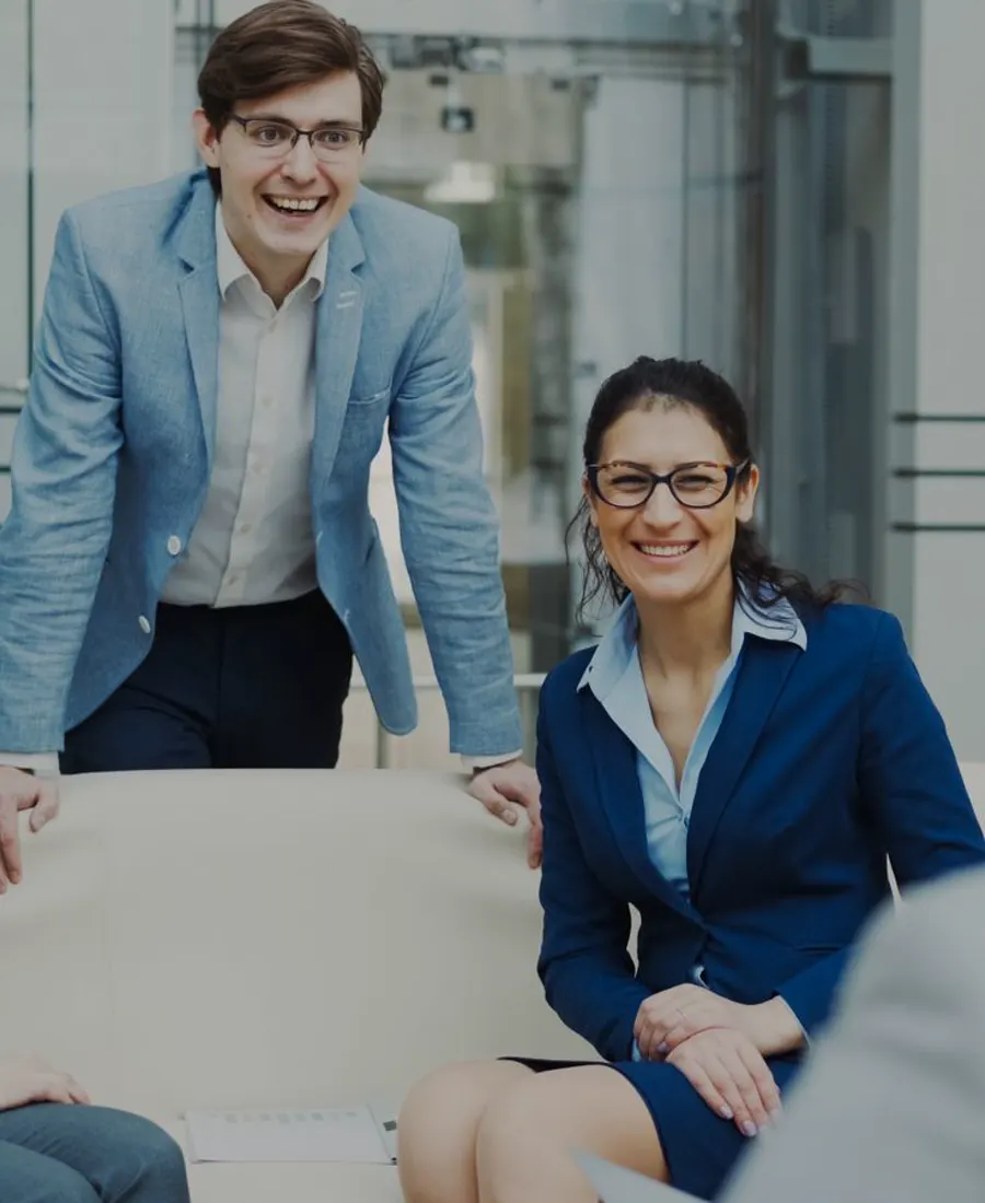 Colleagues smiling together during a client meeting