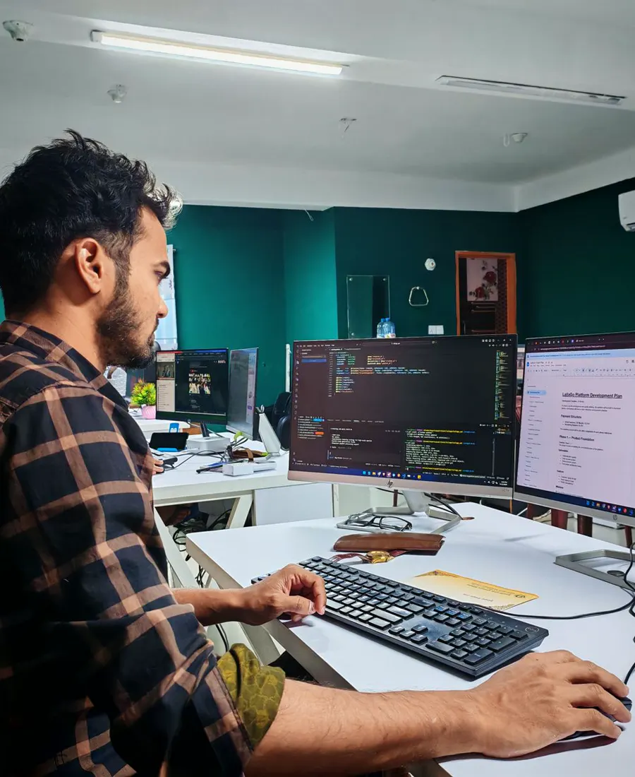 Software engineer working at a multi-monitor workstation
