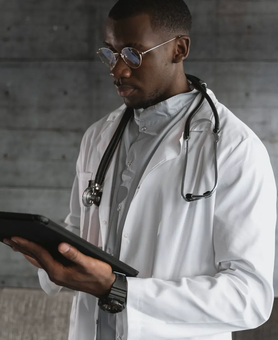Physician reviewing records on a digital tablet